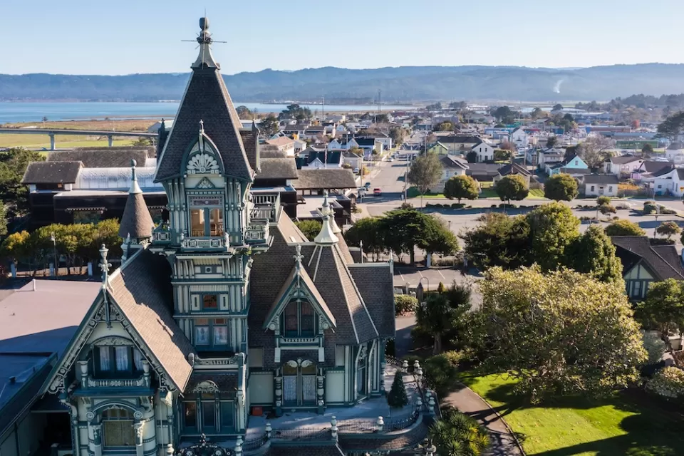 Ornate Victorian home in foreground and neighborhood in Eureka, California.